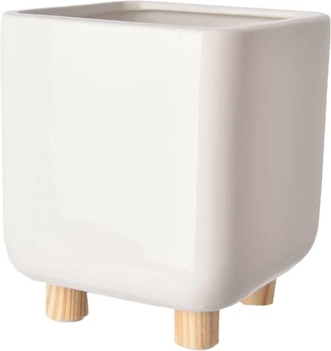 White ceramic planter on wooden legs